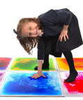 Child playing on 12 Inch Multi Colored Liquid Tiles 6 Pack For Playrooms And Classrooms Interactive Gel Floor Tiles That Move With Every Step Totally Fun For Parties Studios And Decor