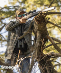 Man aiming PCP Airgun With Scope And Hand Pump Combo.177 Caliber Black Synthetic on tree branch outdoors