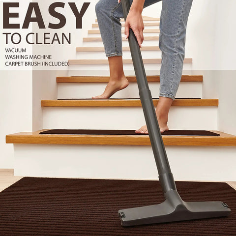 Person vacuuming brown stair treads, showcasing Non Slip Stair Treads For Wood Stairs 14 Pack 8.5 By 30 Inches With Landing Rug