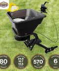 12V Grass Seed And Fertilizer Spreader With 80 Pound Capacity Hitch Mount Receiver Rain Protector For ATV UTV Or Utility Tractor 6 Foot Broadcast Width Heavy Duty 12V DC Motor with seed being poured in.