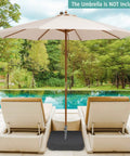 Heavy Duty Beefy 220 Pound Patio Umbrella Base With Sandbags stabilizing umbrella by poolside, fits poles up to 1.9 inches