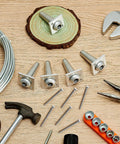 Pro Grade Anchor Vise Set For 8 To 11 Gauge Wire, Includes 4 Vises And Galvanized Wire, tools and screws on wooden surface