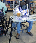 Built Rugged Foldable Welding And Fixturing Table Packing 500 Pound Capacity And Industry Standard Holes in use with welder.