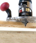 Dead Nuts Universal Compact Router Sub Base Quick Adjust Plate in action with trim router and wood shavings flying.