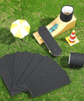 24 Pack Black Fingerboard Foam Grip Tape 110 x 38 x 2 mm, anti slip, durable adhesive, displayed on grass with mini skateboard