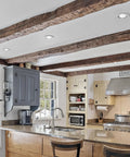 Big Time Brightness Rotatable Led Retrofit Downlight Gimbal in a kitchen ceiling with exposed beams and modern decor.