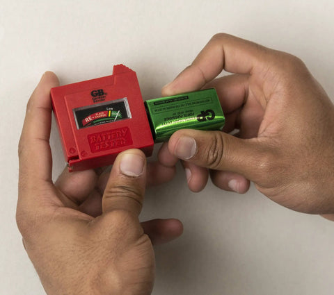 Person using a red battery tester from Household Electrical Tester Kit For Do It Yourself Homeowners With Voltage Tester, GFCI Tester.
