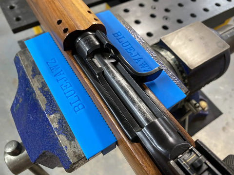 Heavy Duty Heat Resistant Magnetic Soft Jaws For Bench Vise Drill Press Clamps, blue jaws holding wooden rifle stock in a vise.