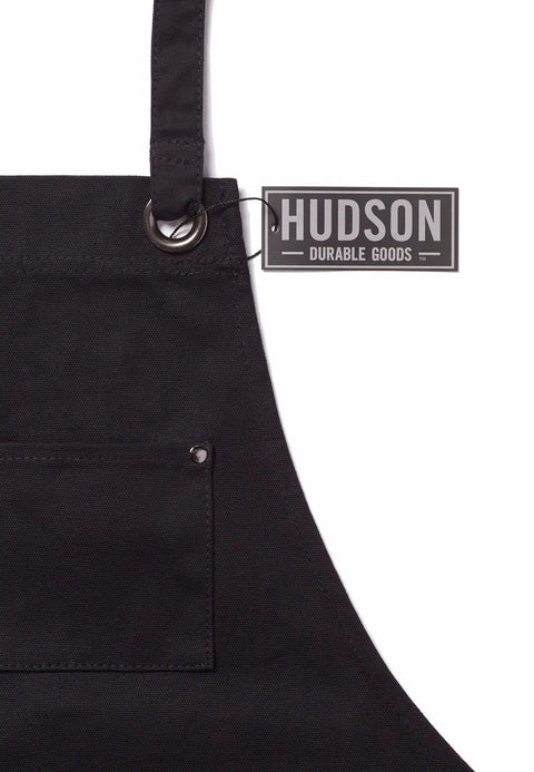 Close-up of Deluxe Waxed Canvas Tool Apron material with focus on front pocket and durable metal ring accent.