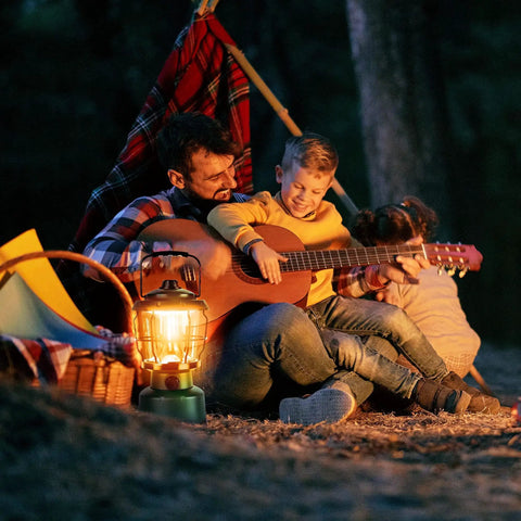 Family camping with Ultra Bright 2500 Lumen Rechargeable Camping Lantern for power outages and emergencies in a forest setting.