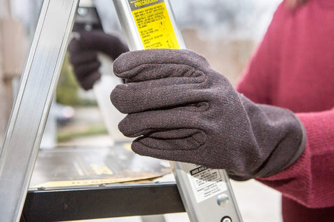 Brown Jersey Winter Work Gloves With Red Fleece Lining for warmth shown gripping ladder outdoors