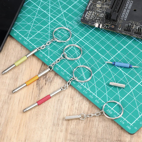 Handy 3-In-1 Eyeglass Repair Kit with keychain screwdrivers in five colors on a green cutting mat for electronics and glasses repair.