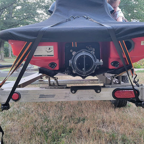 Two Pack 2 Inch Retractable Ratchet Straps With Storage Bag securing a boat on a trailer