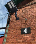 90 Degree Wall Mount L Shape Bracket For Slip Fit LED Lights installed on brick wall outdoors for weatherproof lighting