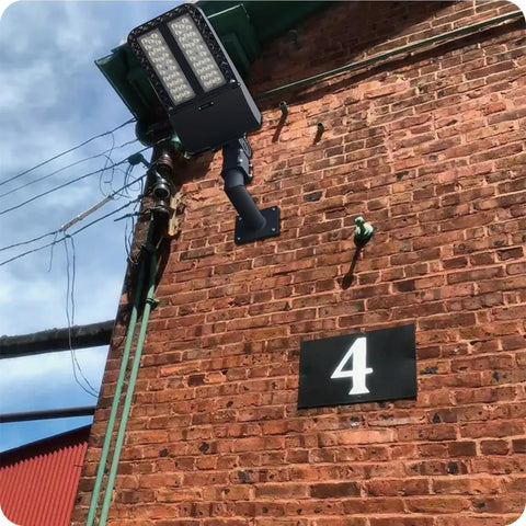90 Degree Wall Mount L Shape Bracket For Slip Fit LED Lights installed on brick wall outdoors for weatherproof lighting