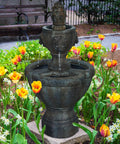 2 Tier Outdoor Fountain in Polyresin with Lion Head Details and Realistic Stone Look Yard Art in a garden setting