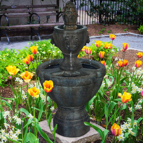 2 Tier Outdoor Fountain in Polyresin with Lion Head Details and Realistic Stone Look Yard Art in a garden setting