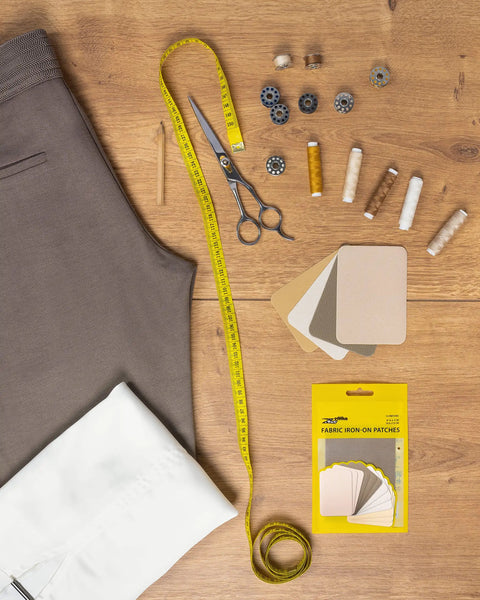 Premium Quality Fabric Iron On Patches Kit With Ultra Strong Glue, 12 Patches In Shades Of Brown Beige And Khaki on wooden table
