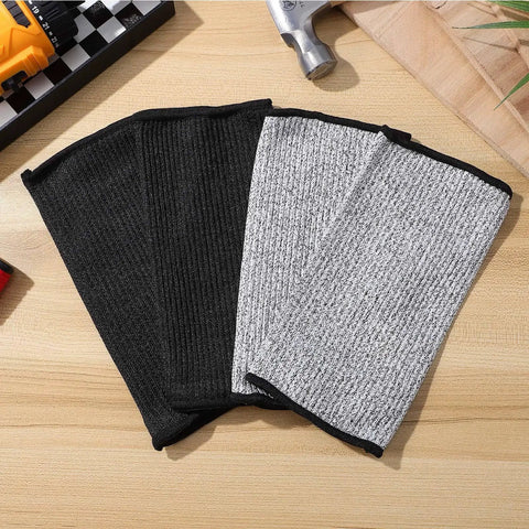 Real Deal Cut Resistant Arm Sleeves For Mechanics And Gardeners With Snug Stretch Fit Anti Puncture Forearm Guards in black and gray.