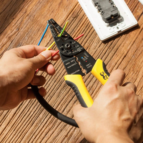 Hands using an 8 Inch Wire Stripper And Cutter Crimper Tool For 10 To 22 AWG Wires, Cable Stripper With PVC Grip on a wooden surface
