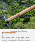Beefy Dual Function Hand Mattock With Hoe Blade And Grubber For Small Garden Trenching And Root Cutting 15.5 Inch 3 Pound Compact Cultivator Tool Made In Germany Since 1899 Heidelberg Design displayed on mossy ground showing wooden handle and metal head.