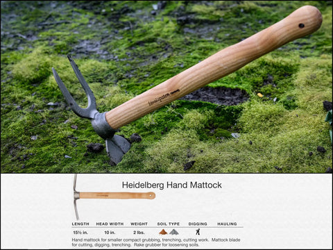 Beefy Dual Function Hand Mattock With Hoe Blade And Grubber For Small Garden Trenching And Root Cutting 15.5 Inch 3 Pound Compact Cultivator Tool Made In Germany Since 1899 Heidelberg Design displayed on mossy ground showing wooden handle and metal head.