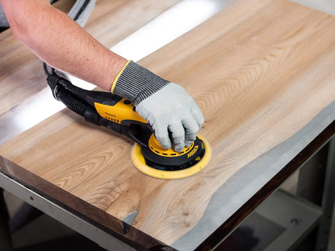 Top Tier 6 Inch Random Orbital Sander Featuring A Smooth Brushless Motor And Effective Dust Extraction Built For Rough Woodshop Jobs drywall sanding on wood surface.