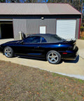 Top Shelf Tinted Blue Paint Basecoat Gallon Ready To Spray With Slow Reducer Blend For Ultra Smooth Automotive Finish That Hits Perfect And Looks Totally Fresh On Any Ride seen on a black convertible car in a driveway.