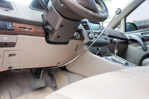 Wingbrake-V driver training brake installed in car; metal cable spans console toward steering wheel.