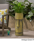 Outdoor Easter Island Tiki Urn Planter in Antique Green Finish for Patio or Garden, Cast Stone Backyard Vase beside patio chair