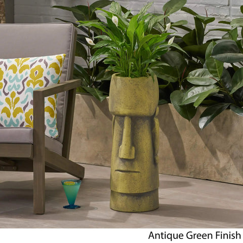 Outdoor Easter Island Tiki Urn Planter in Antique Green Finish for Patio or Garden, Cast Stone Backyard Vase beside patio chair
