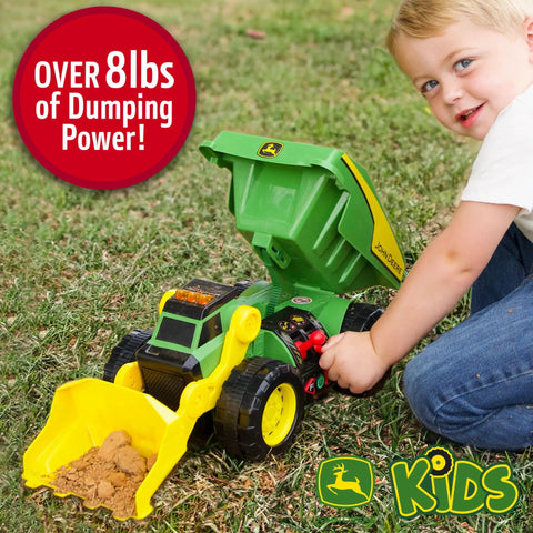 Child playing with Motorized Dig Rig 2 In 1 Toy Dump Truck And Front Loader with realistic lights and sounds in backyard.