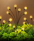 Solar Firefly Lights Outdoor Waterproof With Crystal Ball Swaying Design illuminating a garden with warm white LEDs at night