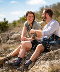 Two hikers resting on rocks with 8 Ounce Wide Mouth Stainless Steel Flask With Leakproof Hinge Cap Insulated And BPA Free