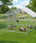 Heavy Duty Metal Chicken Coop With Waterproof UV Resistant Cover And Perch Walk In Outdoor Run For Yard Or Farm Built To Last Large 9.8 Ft L x 13.2 Ft W x 6.4 Ft H Spire Roof Galvanized Steel Frame Keeps Chickens Safe From Rain Wind And Predators shown in a green yard setting
