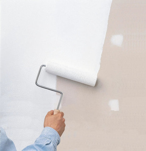 Person painting a wall with White Interior Water Base Primer And Sealer Locks In Stubborn Stains On Walls Doors Trim And Concrete Fast Drying Low Odor Formula.