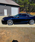 Top Shelf Tinted Blue Paint Basecoat Gallon Ready To Spray With Slow Reducer Blend For Ultra Smooth Automotive Finish That Hits Perfect And Looks Totally Fresh On Any Ride on a black convertible car.