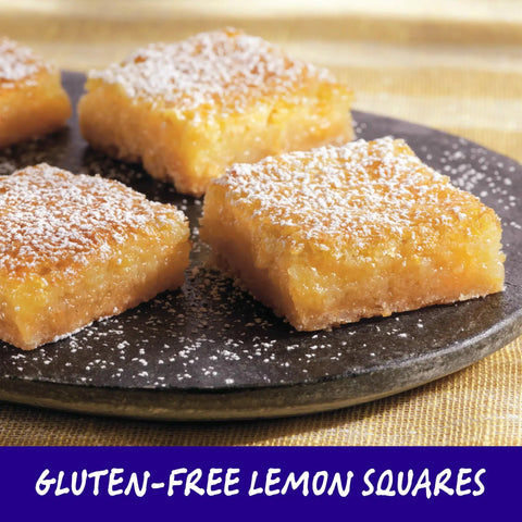 Gluten-free lemon squares with powdered sugar on a black plate, highlighting Gluten Free Pancake And Baking Mix For Fluffy Pancakes.