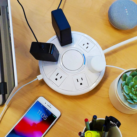 Six Outlet Surge Protector With USB Charging Station 1080 Joules 6 Ft Cord on desk, devices plugged in