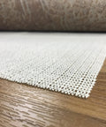 Keeps Rugs Anchored Solid On Hardwood Or Tile Floors Dropping The Slide Hassle This Cream Open Weave Rug Pad on wood floor.