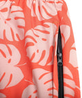 Close-up of Orange Mens Swim Trunks No Lining Beach Shorts With Two Zip Pockets Quick Dry Fabric Drift Surf Vibe Plantain Leaves Pattern.