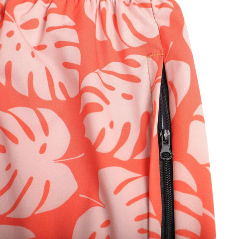 Close-up of Orange Mens Swim Trunks No Lining Beach Shorts With Two Zip Pockets Quick Dry Fabric Drift Surf Vibe Plantain Leaves Pattern.