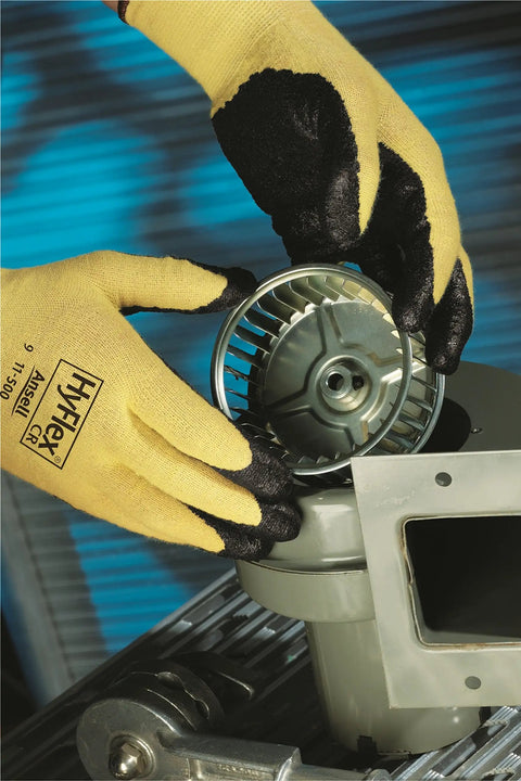Hands wearing HyFlex 11-500 Kevlar Cut-Resistant Work Glove With Foam Nitrile Grip handling metal part, X-Large Size 10