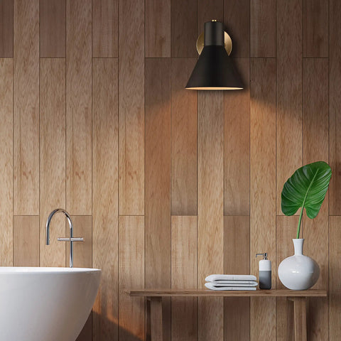Towner One Wall Sconce Vanity Light In Satin Brass Modern Bath Fixture for hallways, mounted on wooden wall above bathroom vanity.