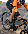 Cyclist wearing orange jacket on MTB with Bike Pedal Straps Set Of 2 Heavy Duty Nylon Footrest Strips Adjustable Biking Accessory