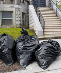 Hella Tough 95 Gallon Contractor Garbage Bags Built Like Armor For Industrial Sites With Easy Tie Necks Top Shelf 2 Mil Trash Can Liners Workhorse Strength Pack Of 25 stacked beside a tree.