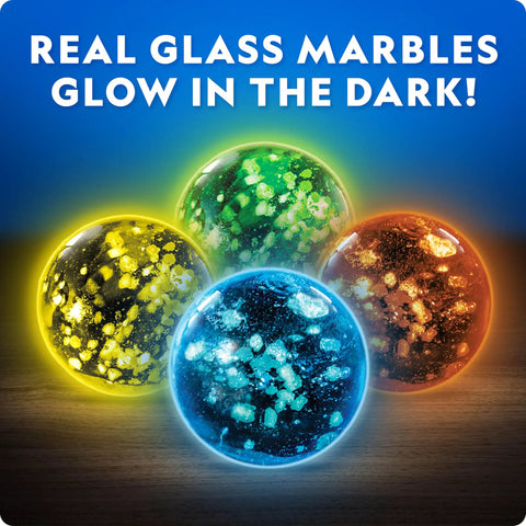 Four glow-in-the-dark glass marbles from the Glowing Marble Run Kit With 15 Glow-In-The-Dark Glass Marbles And Storage Bag.