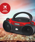 Portable Top-Loading CD Boombox With AM/FM Radio And 3.5mm Line In, red and black design, on wooden surface, outdoor backdrop