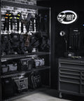 Garage storage with various tool bags including 18 Inch FlatTop Weather Resistant Tool Bag With All Terrain Bottom And Weatherproof Front Pocket 12 Interior Pockets Removable Padded Shoulder Strap Gray Assembled In The USA displayed on shelves.