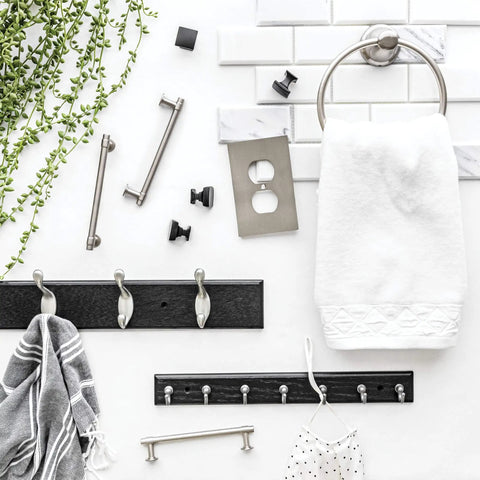 Black Wall Mount Key Rack With 7 Hooks For Hallway And Entry next to towel ring and green leaves against white tile wall.